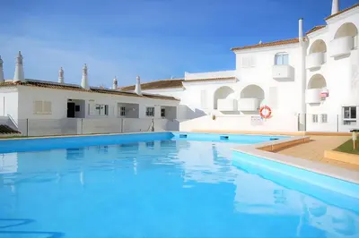 a swimming pool in front of a building at São Rafael 1 Bedroom with Pool in Albufeira