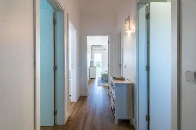 a hallway with blue doors and a desk in a room at São Rafael 1 Bedroom with Pool in Albufeira
