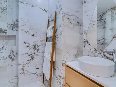a white bathroom with a sink and a mirror at Art and Sea 2 bedroom apartment in Quarteira