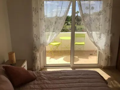 a bedroom with a bed and a view of a patio at 2 Bedroom Townhouse, Vale de Parra in Guia