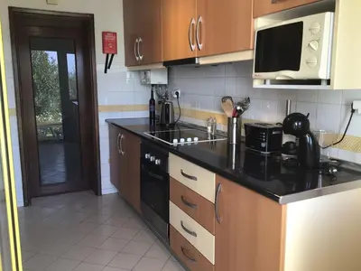 a kitchen with a black counter top and a stove at 2 Bedroom Townhouse, Vale de Parra in Guia