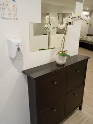 a dresser with flowers in a vase on it at Panoramic View in Albufeira