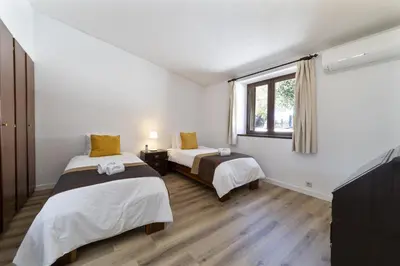 a room with two beds and a window at Casa da Colina in Albufeira
