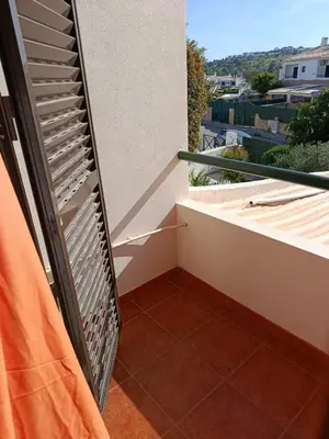 a balcony with a heater on the side of a building at Villa Vacations Marie in Albufeira