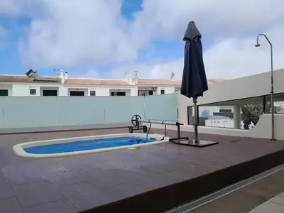 a swimming pool with an umbrella on a patio at Villa Vacations Marie in Albufeira