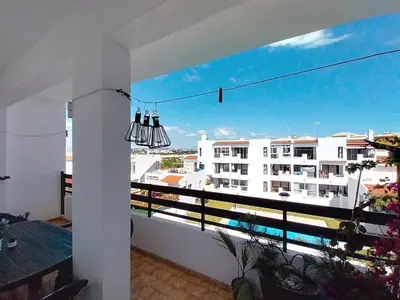 a bedroom with a black and white bed in a room at Central View 990 meters from beach on foot in Albufeira