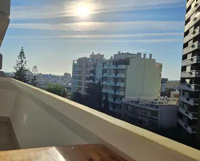 a view of a city from the balcony of a building at Apartamento moderno com vista para o mar em Faro in Faro