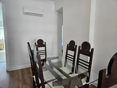 a glass dining room table with four chairs around it at Apartamento moderno com vista para o mar em Faro in Faro