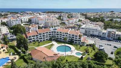 two men are flying in the air at #309 Marine Apartamento by Home Holidays in Albufeira