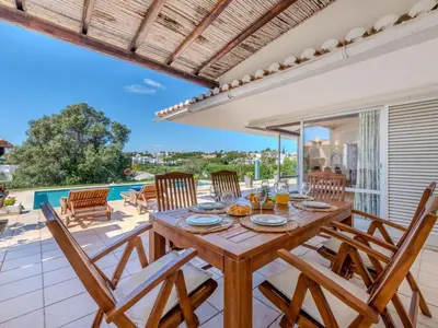 a dining room with a table and chairs on a patio at Villa Rosa by Interhome in Sesmarias
