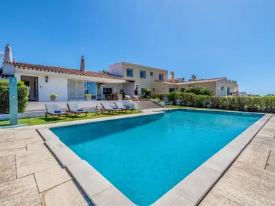 a villa with a swimming pool in front of a house at Villa Rosa by Interhome in Sesmarias
