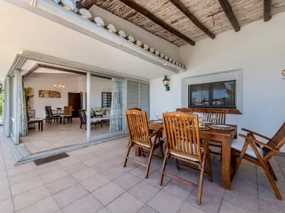 a dining room with a table and chairs at Villa Rosa by Interhome in Sesmarias