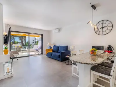 a patio with a table and chairs and a view of a pool at Apartment Brisa dos Pinheiros by Interhome in Vilamoura