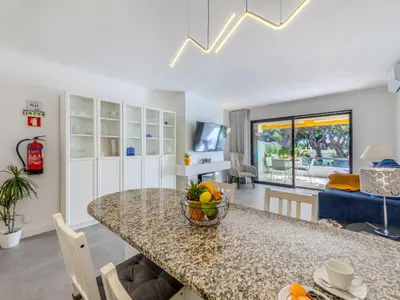 a living room with a blue couch and a tv at Apartment Brisa dos Pinheiros by Interhome in Vilamoura