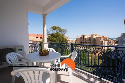 a balcony with a table and chairs and a view at #316 Flat New Town by Home Holidays in Albufeira