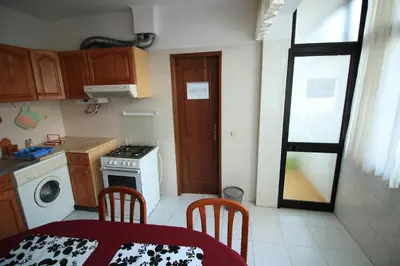 a small kitchen with a table and chairs and a stove at Modern Apartment in Albufeira in Albufeira