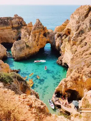 a group of people swimming in a cave in the water at Modern Apartment in Albufeira in Albufeira