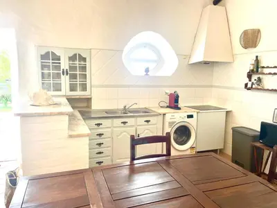 a kitchen with a sink and a washing machine at Toca das Manas in Roja- Pé