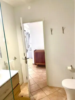 a bathroom with a toilet and a sink at Toca das Manas in Roja- Pé
