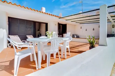 a white balcony with a white table and chairs at Volta da Vinha, 3bdr Private Vila in Vilamoura in Vilamoura