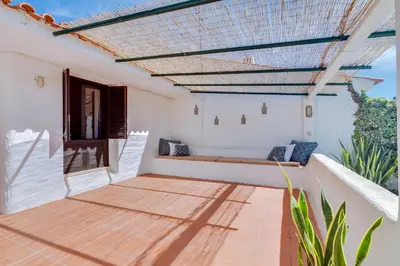 an outdoor patio with a pergola and a bench at Volta da Vinha, 3bdr Private Vila in Vilamoura in Vilamoura