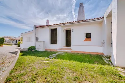 a white house with two towers on a street at Volta da Vinha, 3bdr Private Vila in Vilamoura in Vilamoura