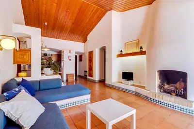 a living room with a blue couch and a fireplace at Volta da Vinha, 3bdr Private Vila in Vilamoura in Vilamoura