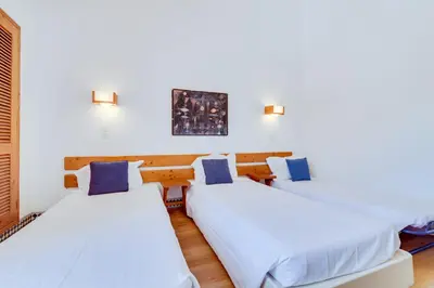 two beds in a room with white walls at Volta da Vinha, 3bdr Private Vila in Vilamoura in Vilamoura