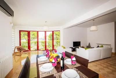 a dining room with a wooden table and chairs at Villa Marina by Algarve Vacation in Albufeira