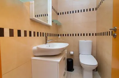 a bathroom with a toilet and a sink at Apartamento Varandas do Mar in Albufeira
