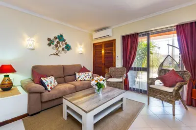 a living room with a couch and a table at Clementina Apartment in Albufeira