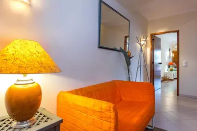 a living room with a couch and a lamp on a table at Clementina Apartment in Albufeira