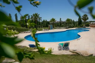 a large swimming pool with two chairs in a yard at Spacious Villa by Algarve Dream Holidays in Albufeira