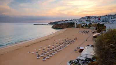 a sandy beach with umbrellas and the ocean at Spacious Villa by Algarve Dream Holidays in Albufeira
