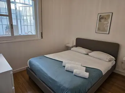 a bedroom with a bed with two towels on it at Blife Luya private rooms in Faro