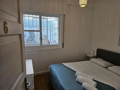 a bedroom with a bed with two towels on it at Blife Luya private rooms in Faro