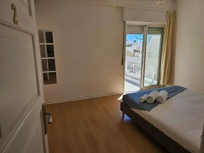 a bedroom with a bed with two pillows and a window at Blife Luya private rooms in Faro