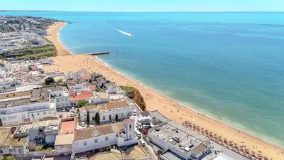 an aerial view of a beach and the ocean at Apartmento Estrela de Albufeira Old Town Beach in Albufeira