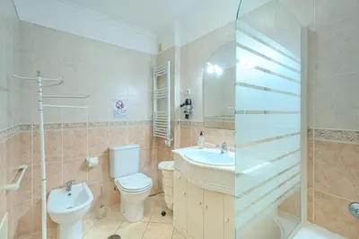 a bathroom with a toilet and a sink and a shower at Apartmento Estrela de Albufeira Old Town Beach in Albufeira