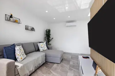 a living room with a couch and a table at Amazing Oura Beach Apartment in Albufeira