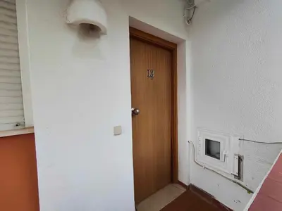 a hallway with a door and a tv on the wall at Albufeira INN - Vale Navio T2 in Albufeira