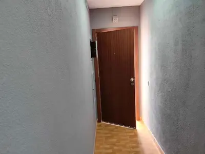 an empty hallway with a brown door and a wooden floor at Albufeira INN - Vale Navio T2 in Albufeira