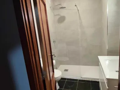 a bathroom with a shower and a toilet and a sink at Albufeira INN - Vale Navio T2 in Albufeira