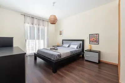a bedroom with a bed and a large window at Vacances Tranquilles in Olhos de Água