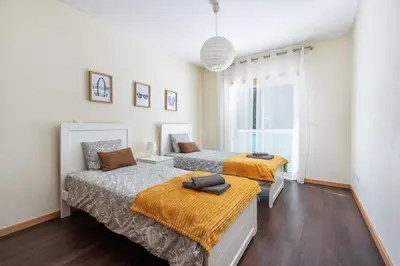 a bedroom with two beds and a window at Vacances Tranquilles in Olhos de Água