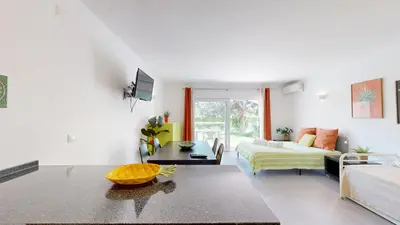 a living room with a bed and a couch at Apartamento Studio Sao Rafael, 450m Praia in Albufeira