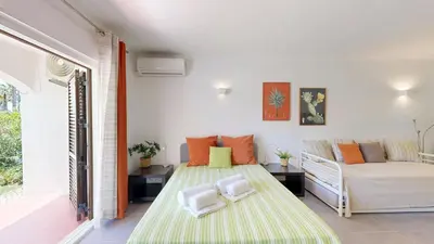 a living room with two beds and a couch at Apartamento Studio Sao Rafael, 450m Praia in Albufeira