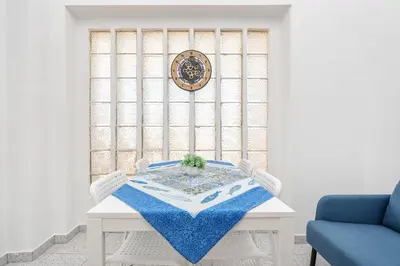 a white table with a blue table cloth on it at Blife Riamya private rooms in Faro