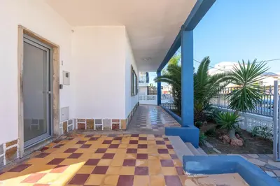 a hallway of a house with a checkered floor at Blife Riamya private rooms in Faro