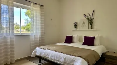 a bedroom with a bed and a window at Casa do Campo by Check-in Portugal in Tunes